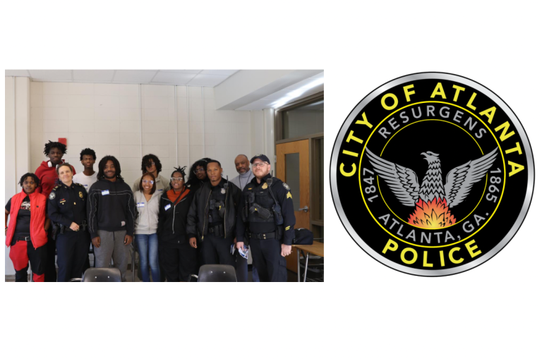 Year Two Participants and police officers stand together indoors; Atlanta Police Department logo is shown beside them.
