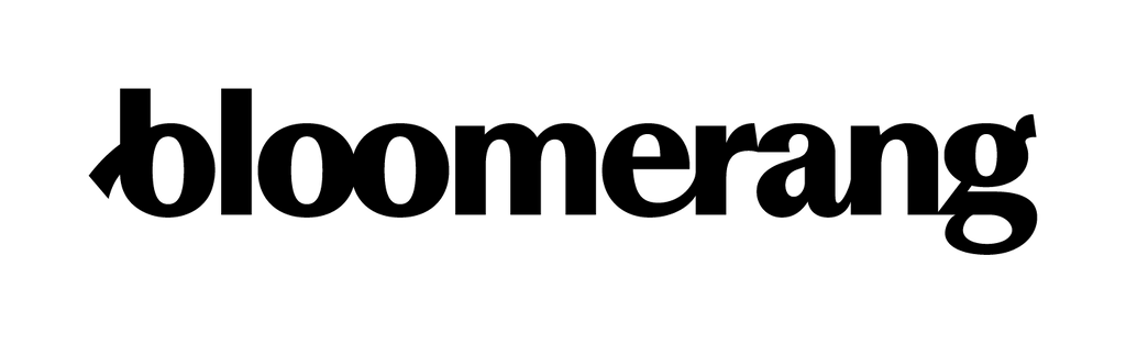 A person sits at a desk, working on donor management software like Bloomerang with visible code on the screen.