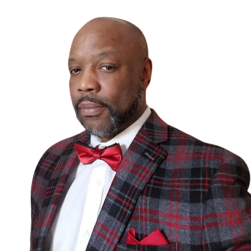 Man wearing a red bow tie and plaid suit jacket, looking at the camera—perfect for your Podcast Page.